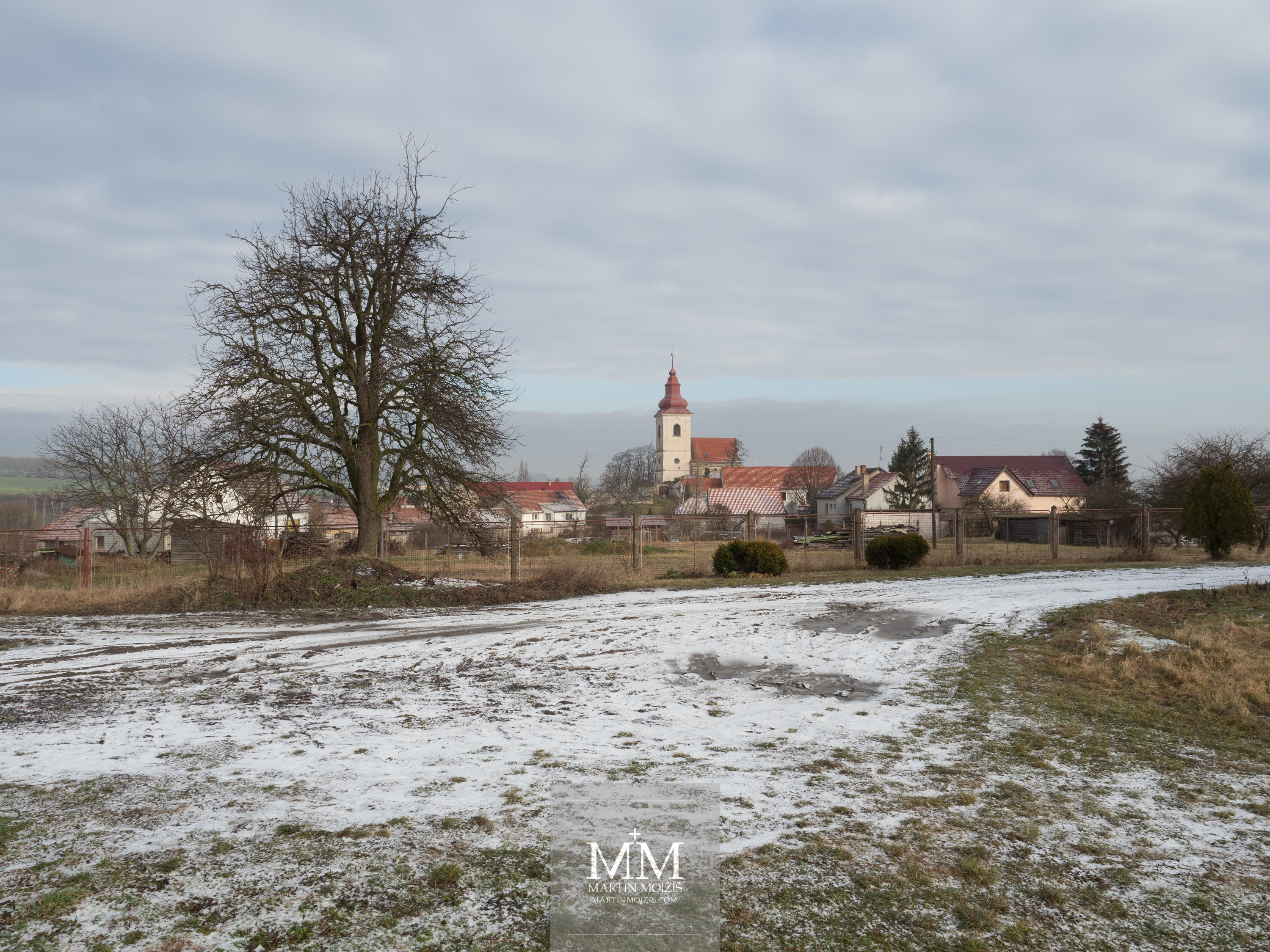 Village in winter, church in the background. Photograph created with Olympus 12 - 40 mm 2.8 Pro lens.